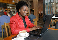 A woman working from a coffee shop.